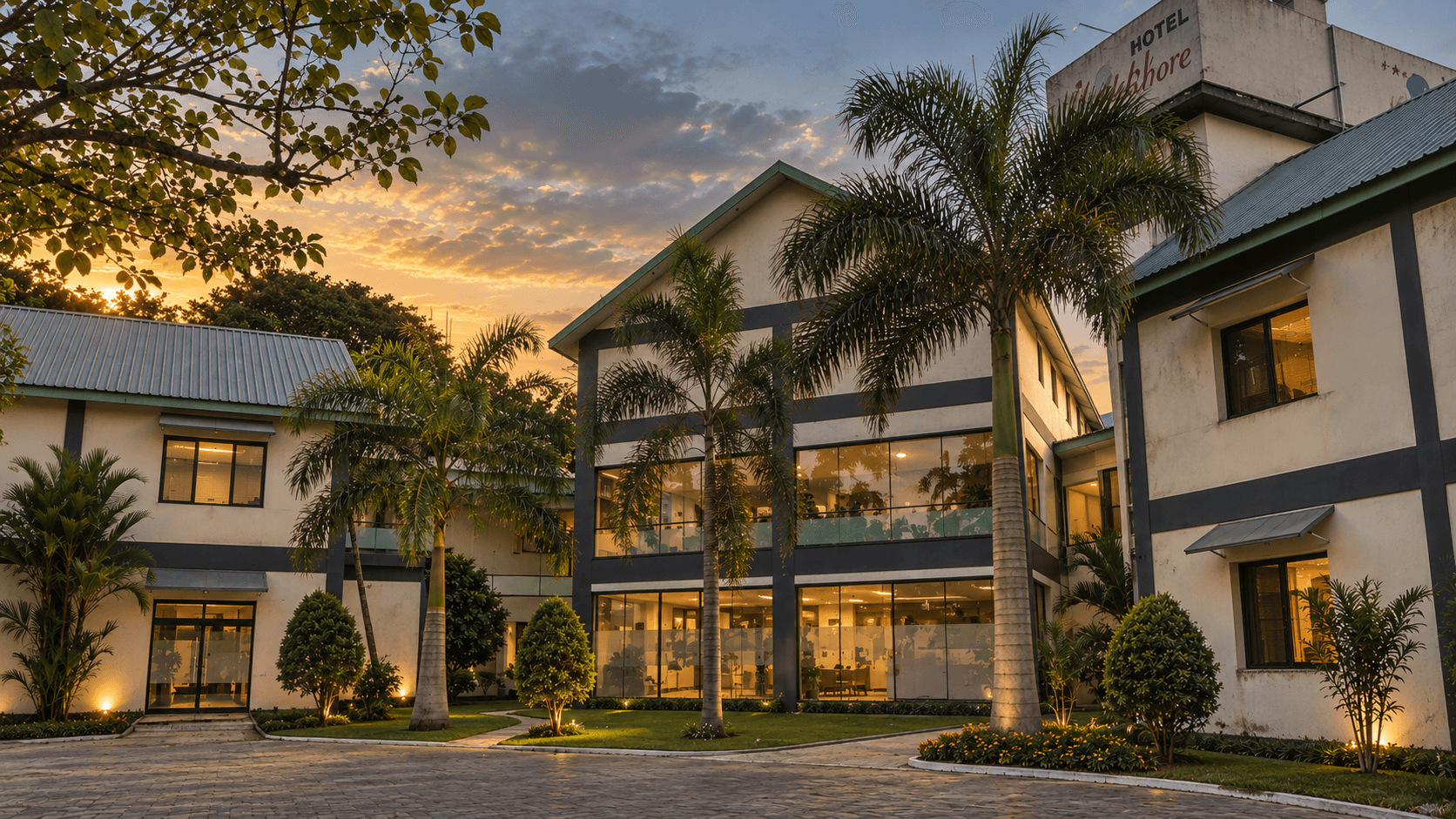 Palmshore Hotel illuminated courtyard and palm trees in evening light