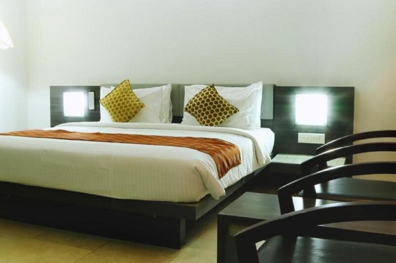Side perspective with handcrafted armchairs and brass lighting